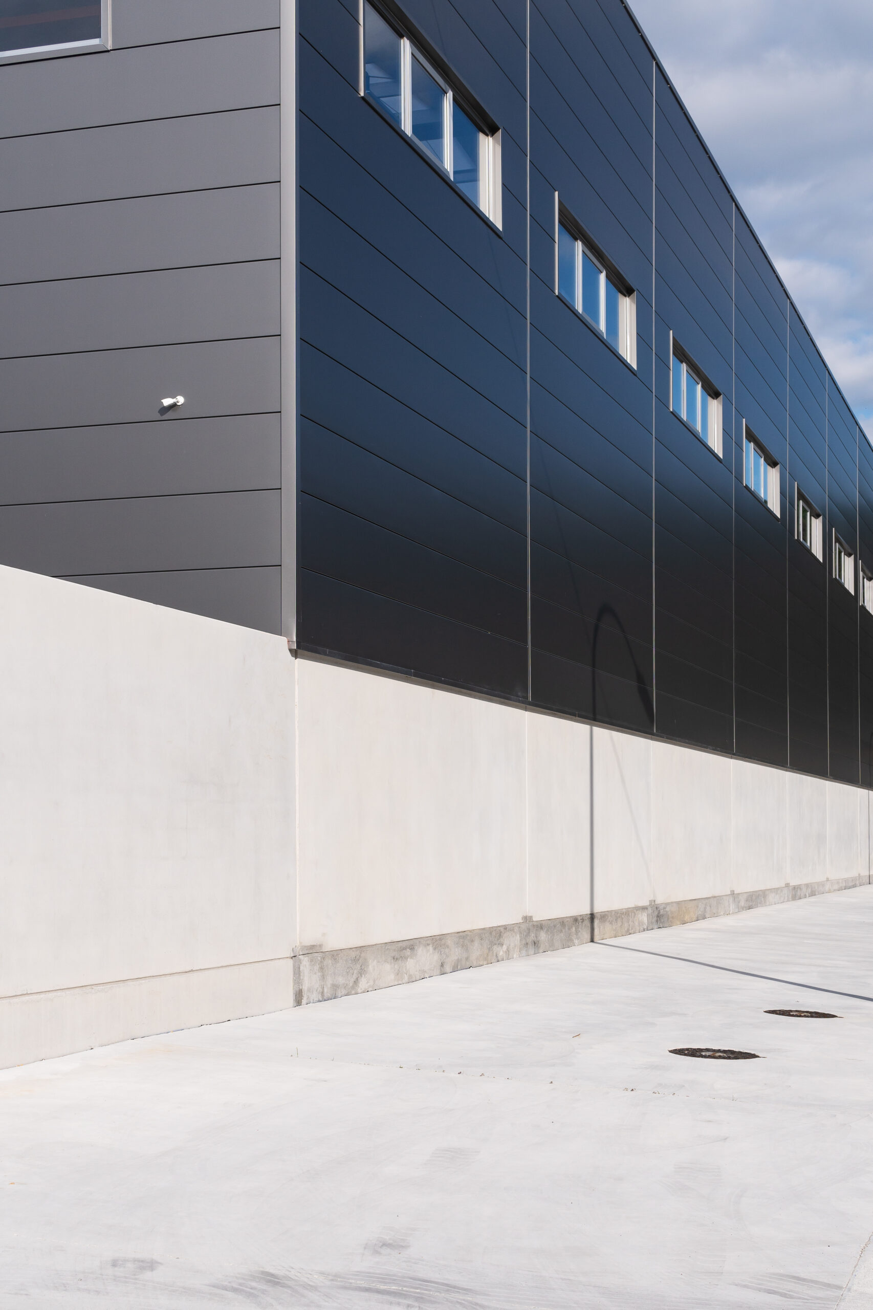 industrial building facade with metallic cladding. industrial warehouse